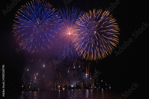 High-quality fireworks background. Colorful pyrotechnic explosions on a dark night sky, ideal as festive backdrop for New Year, Independence Day, or celebration designs. Perfect for posters, banners, 