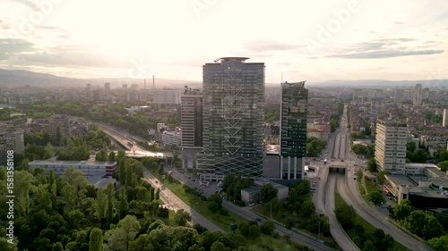 4k Aerial drone footage of Millennium Centre in Sofia, Bulgaria. Skyscraper seen from a drone. Flyover footage of tall building in an urban enrivorment next to a green summer park. Establishing shot.
