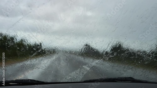 Raindrops on Car Windshield in Rainy Weather