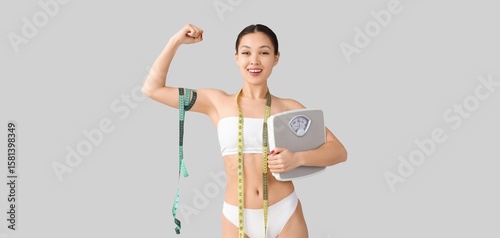 Happy Asian woman in underw...
