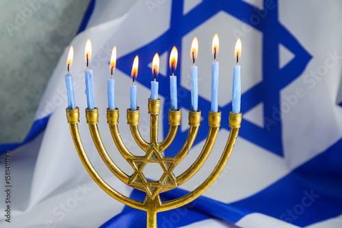 Menorah with burning candle...