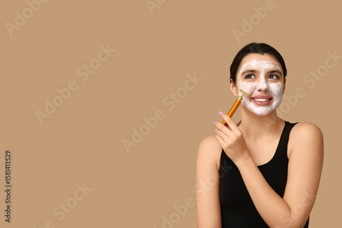 Happy young woman with faci...