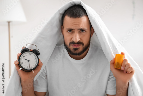 Stressed young man with ala...