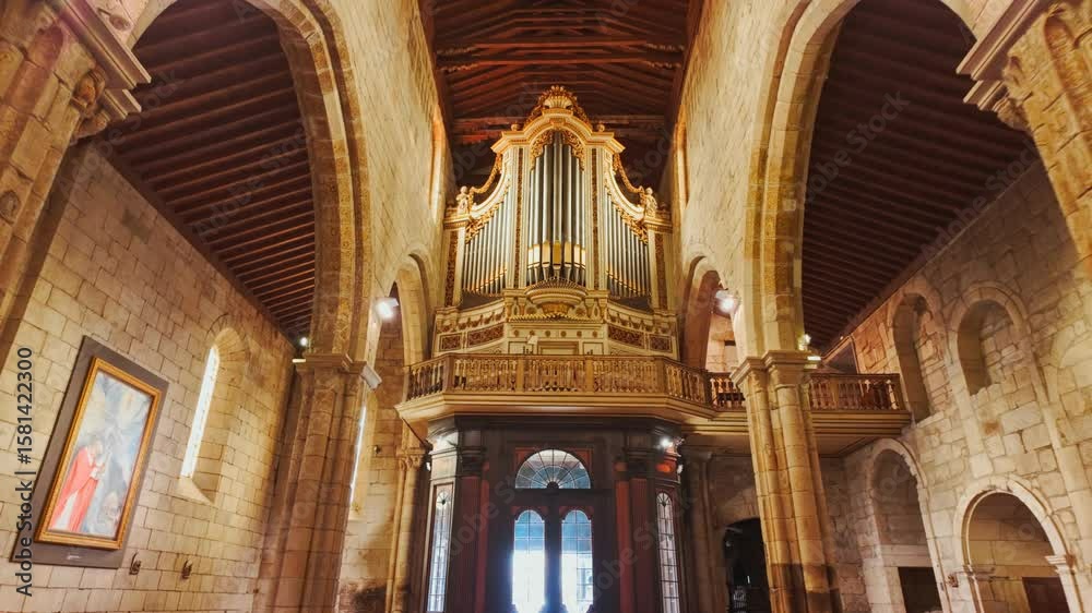 Vaulted nave of Interior of Igreja de Nossa Senhora da Oliveira Church houses baroque retables carved choir stalls in Guimaraes, Portugal