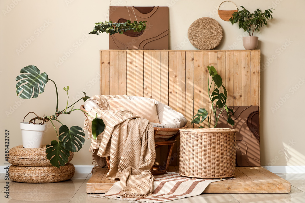 Fototapeta premium Interior of stylish living room with armchair, wicker basket and plants