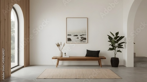 Bright minimalist interior with natural wooden bench, potted plant, round rug, and framed beach photo against a white wall

