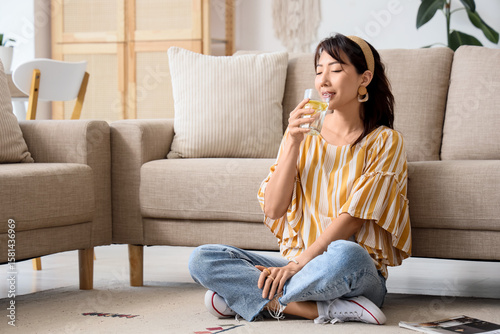 Young Asian woman drinking ...