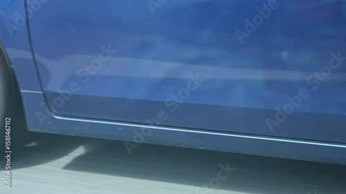 Passing a car in the same direction, close-up of rotating wheels and asphalt in motion