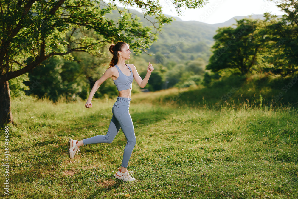 Fit young woman running in activewear in a lush green park setting, embodying healthy lifestyle and outdoor fitness motivation during summer Fit young woman running in activewear in a lush green park setting, embodying healthy lifestyle and outdoor fitness motivation during summer