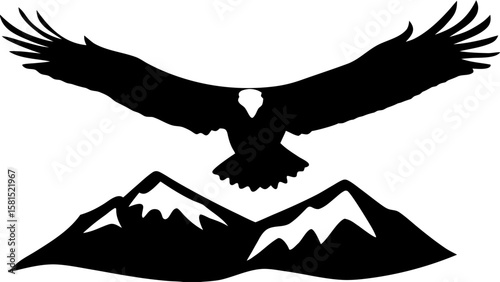 Silhouette of an eagle with outstretched wings flying over a mountain range with snow capped peaks