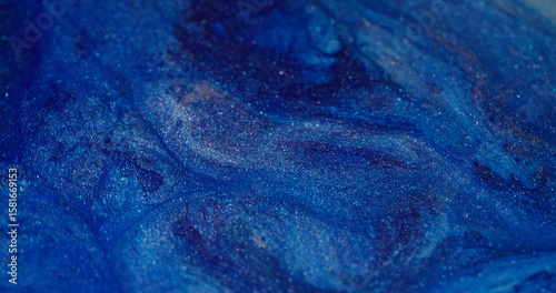 Ink stream. Floating splash. Defocused bright blue color spatter shimmer water texture spreading on abstract creative art background.