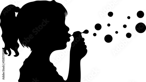 Silhouette of a young girl blowing bubbles with a bubble wand creating floating spheres in the air