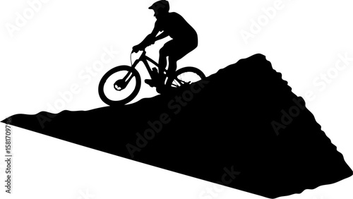 Silhouette of a mountain biker riding down a steep hill with helmet and bike in a black and white scene