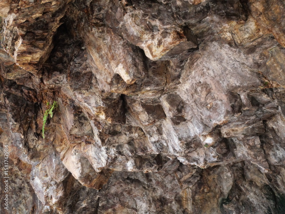 Fototapeta premium A mysterious cave stone with ancient textures, echoing history and natural geological wonders within.