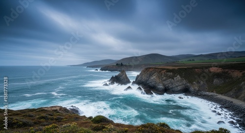 Dramatic coastal scenery showcases rugged cliffs meeting the powerful ocean waves under a cloudy sky, capturing the raw beauty of the natural landscape and the dynamic interaction of land and sea.