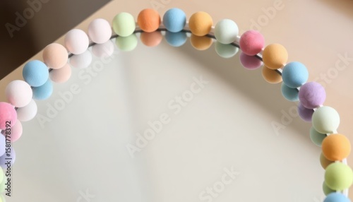 Abstract image of colorful beads reflecting in a shiny surface