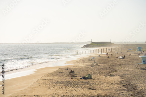 Fototapeta Naklejka Na Ścianę i Meble -  Sunset beach waves and fog 