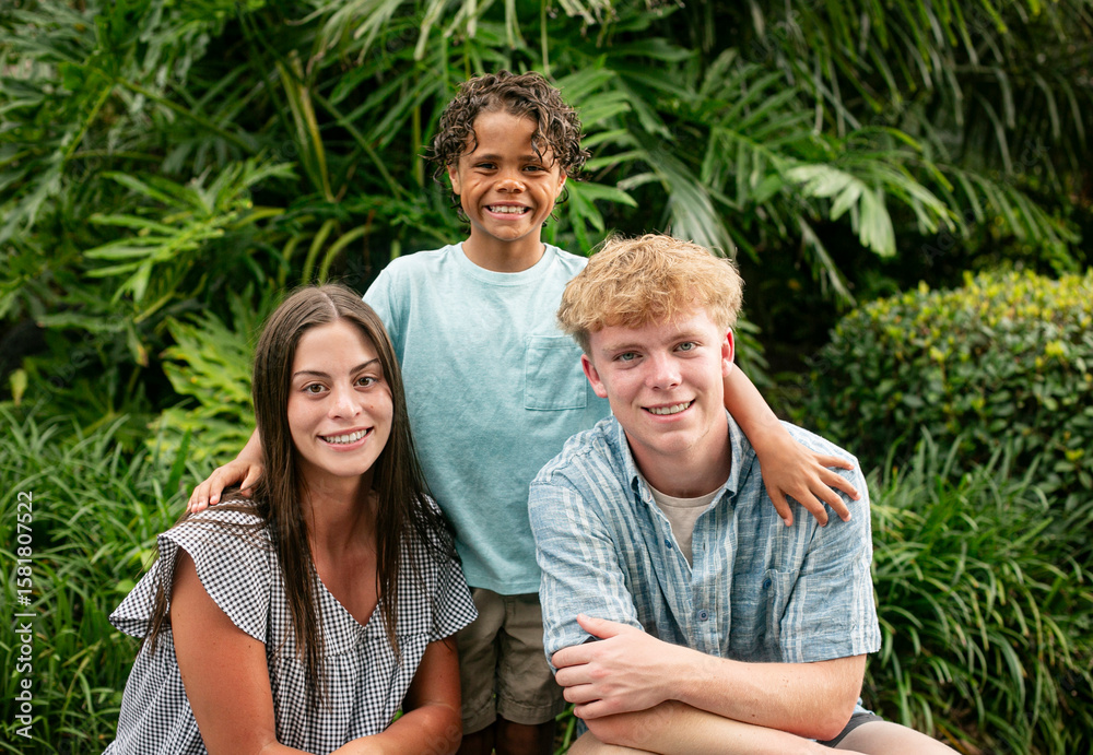 Fototapeta premium Casual Portrait of a diverse group of beautiful children. Cute smiling faces of hispanic girl, African American boy and caucasian boy.