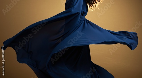 Elegant Woman Dancing in Flowing Blue Dress Moving in Artistic Studio Setting