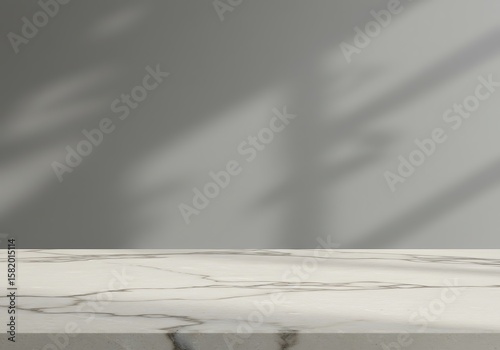 Elegant white marble tabletop against a grey wall, illuminated by soft natural light shadows.

