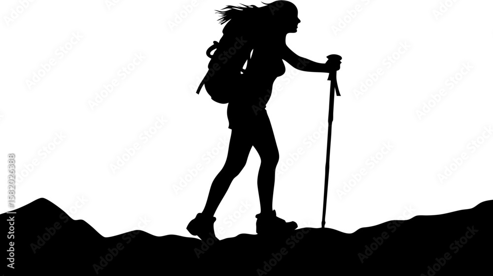 Fototapeta premium Silhouette of a female hiker with a backpack and trekking pole walking on a mountain ridge with windblown hair