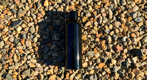 Wallpaper Mural Black bottle on gravel background minimalist product shot Torontodigital.ca