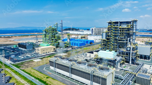 Photos Aerial view of biomass power plant and wind and solar power plant
