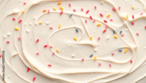Close-up of cake frosting decorated with colorful sprinkles for dessert design