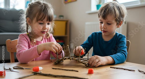 Two children crafting a miniature bridge