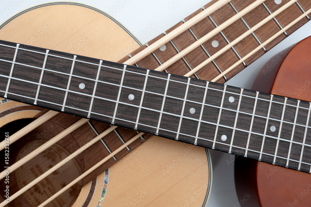 Fototapeta premium Four-string bass ukulele with wooden body and built-in tuner and pickup.