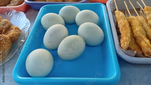 Salted duck eggs with a firm texture and savory taste, traditionally preserved in brine. A popular Asian delicacy often enjoyed with rice or porridge.