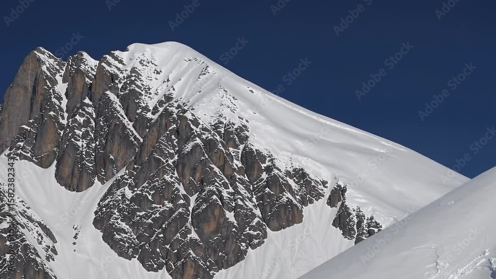 ultra zoom telephoto view of Grossglockner mountain in Austria  showing its towering snow covered peak and surrounding range under a crystal clear blue sky from a northern vantage point