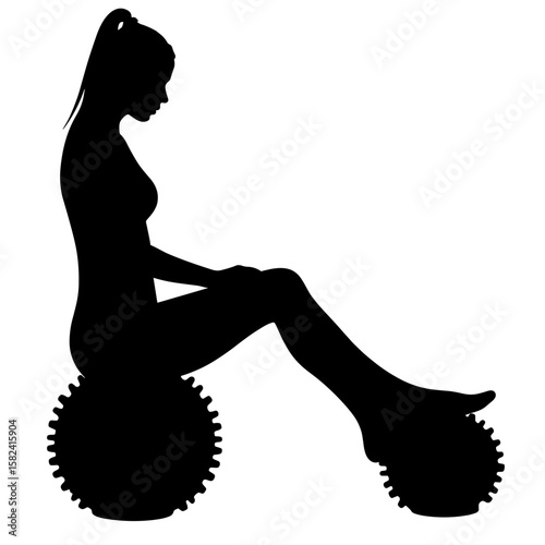 Silhouette of woman using spiky ball massager – foot recovery therapy