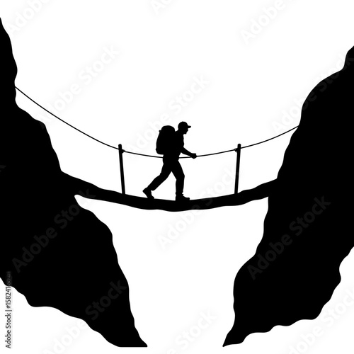 Silhouette of backpacker crossing suspension bridge, adventure and risk, copyspace
