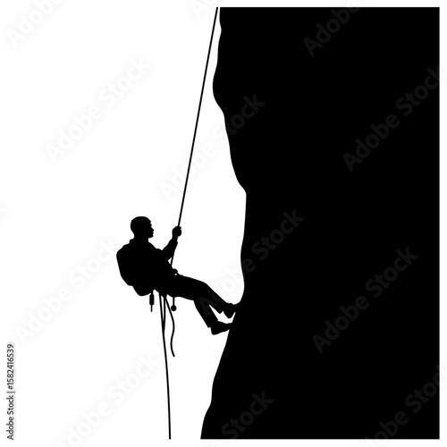 Silhouette of climber rappelling down rock face, adventure safety technique
