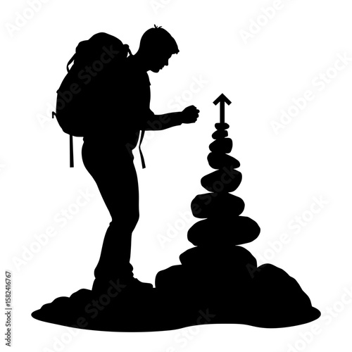 Silhouette of hiker stacking cairn stones, navigation direction aid
