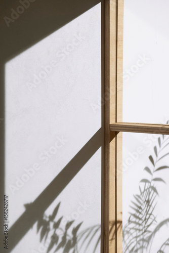 Wallpaper Mural Soft sunlight through wooden windows, shadows, green leaves and texture of white walls. Torontodigital.ca