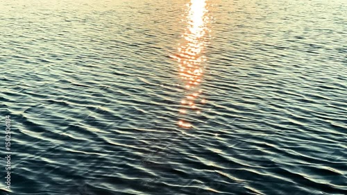 View of a Crystal clear water texture. Natural background. Ripple water reflection. Waves. Waves in motion with splashes	at sunset