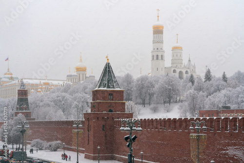 View of the architectural ensemble of the Moscow Kremlin from the embankment of the Moskva River during heavy snowfall, Moscow, Russia
