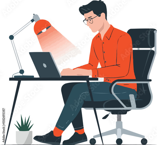 Man working diligently on a laptop at a desk with a desk lamp illuminating his workspace