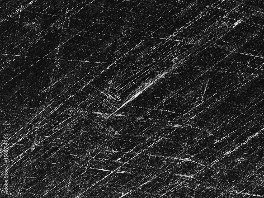 Fototapeta premium Detailed texture of distressed black surface with scratches illuminated by light from above