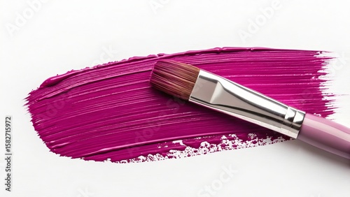 A vibrant purple paint stroke is applied with a brush, isolated on white background, creating a textured artistic effect
