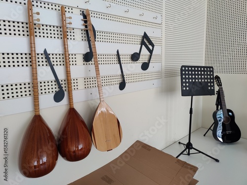 A harmonious blend of tradition and modernity, these stringed instruments—two ouds and a guitar—hang with musical notes, symbolizing a journey of cultural harmony and creative unity.
