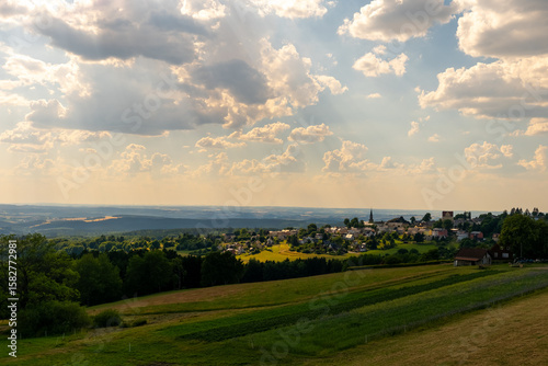 Obraz na plátně Sunlight spills over rolling hills and lush fields in a picturesque countryside