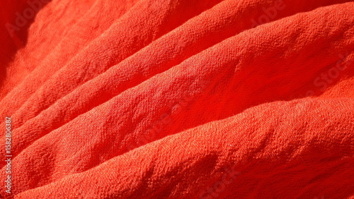 Red summer crinkled, wrinkled fabric for clothes. Red textile background. Red fabric.