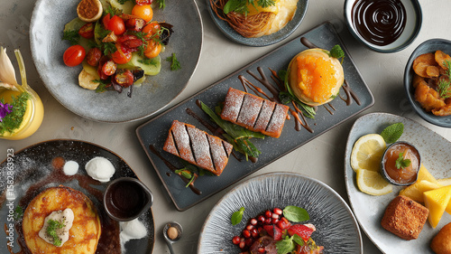 Wallpaper Mural Variety of delicious dishes are artfully arranged on table, showcasing vibrant colors and textures. assortment includes desserts, salads, and main courses, creating inviting and appetizing display Torontodigital.ca