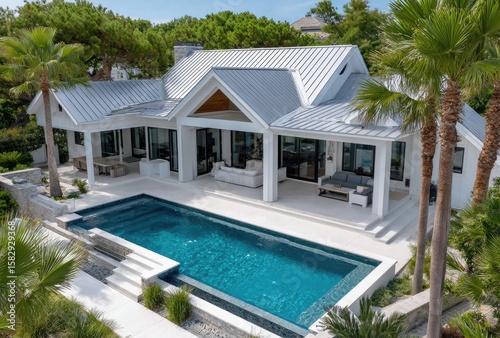 A bird's eye view of an entire modern two-story house with a grey metal roof