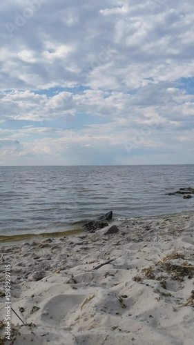 Tranquil Seaside Horizon with Gentle Waves and Clouds