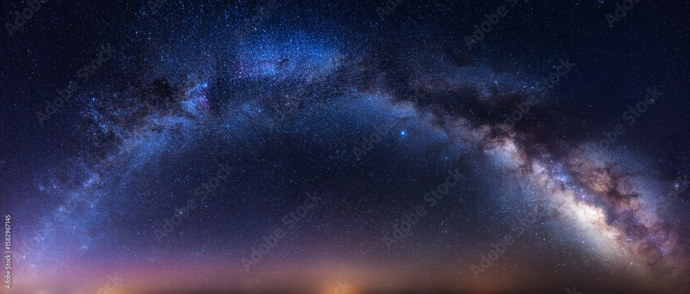 Fototapeta premium The Milky Way galaxy stretches across the night sky, revealing countless stars and cosmic wonders in a breathtaking celestial display.