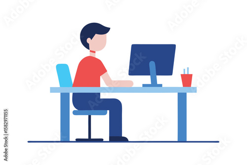 A man sits at a desk and works on his computer